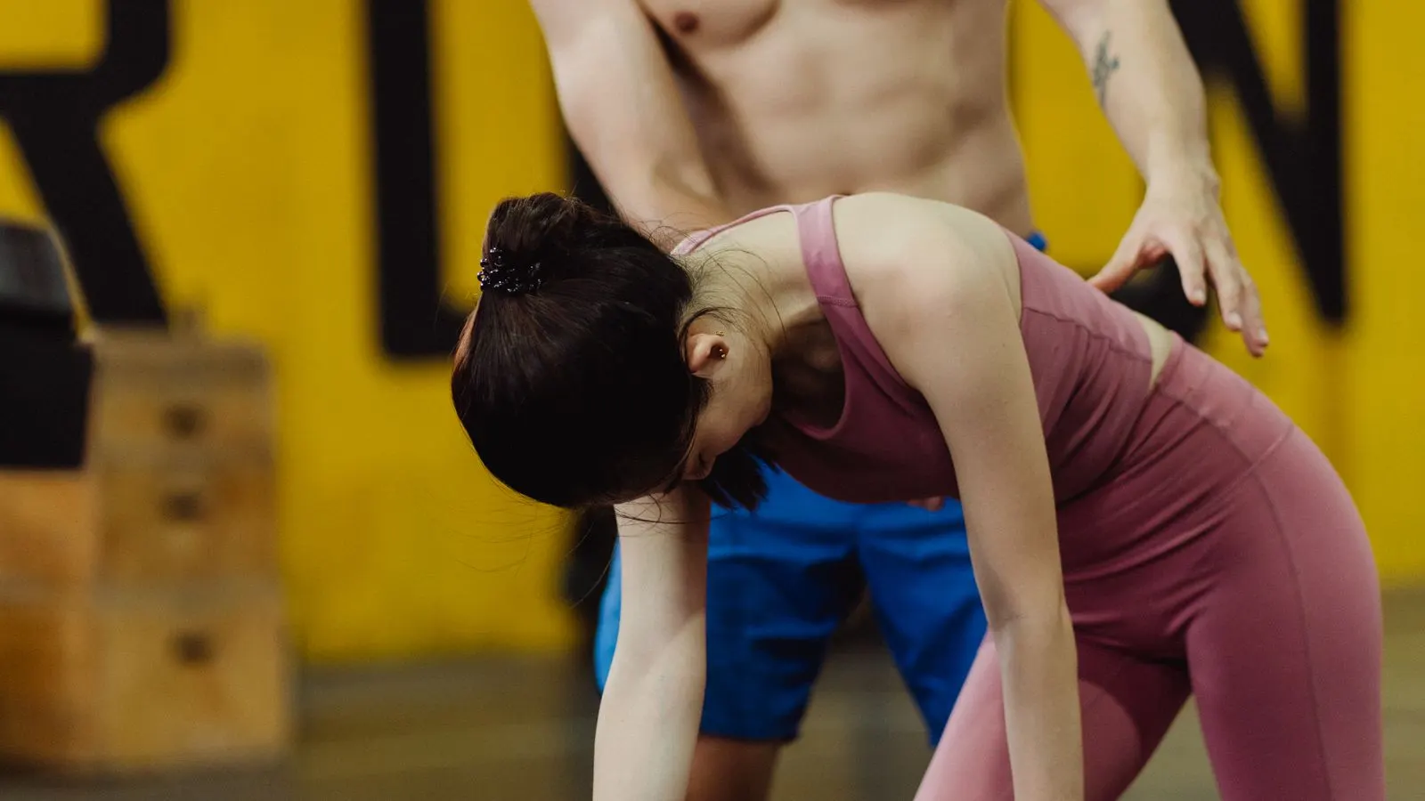 Trainer coaching a woman during a dumbbell workout