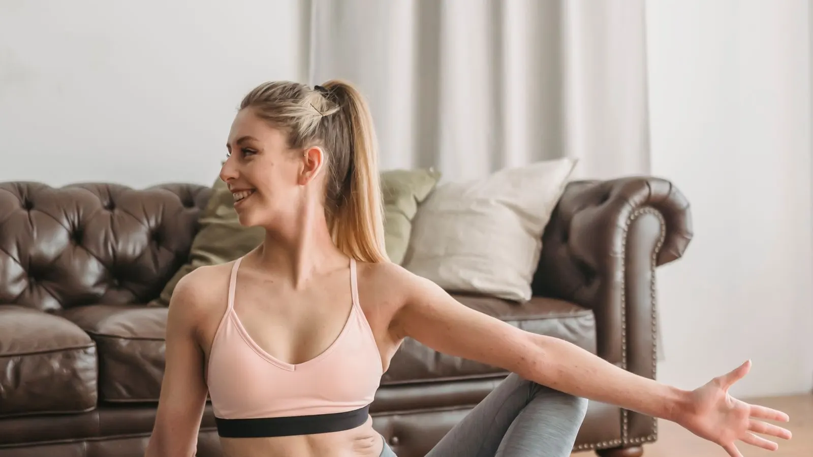 Woman stretching her upper body during a mobility session at home